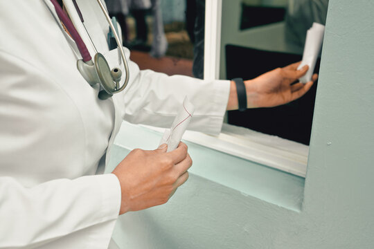 Unrecognizable Latin Female Doctor Handing Out Blood Samples In A Hospital Laboratory