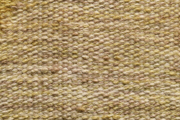 Surface of fabric texture in yellow and brown color. Pale brown wool yarn cloth background. 
