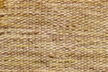 Pale brown wool yarn cloth background. Surface of fabric texture in yellow and brown color. 