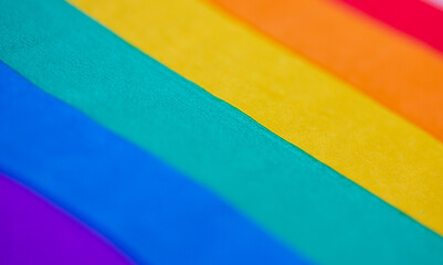 Abstract striped LGBT flag background texture. Textile or paper backdrop of rainbow bright colors....