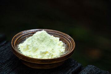 Sulfur or Sulphur powder on nature background.