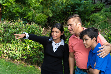 Latino man with his children outdoors