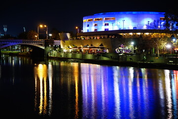 Fototapeta na wymiar City Night Scene with River and Bridge