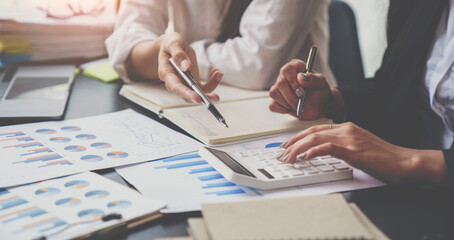 Financial analyst analysis business financial report on the document during a discussion at meeting of corporate showing the results of their successful teamwork, business meeting concept, Marketing