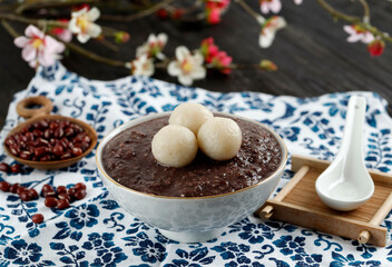 Korean Food Patjuk or Red Bean Porridge Topped with Round Rice Cake