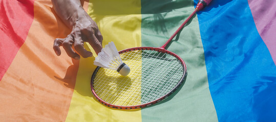 Badminton racket and shuttlecock on lgbt rainbow flag