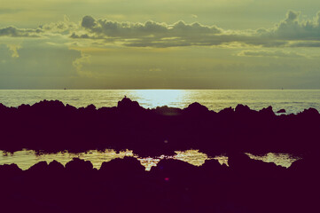 Scenic View Yellowish Light Evening Sun On The Tropical Rocky Beach Of The Village