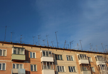 Fototapeta na wymiar homemade metal antennas receive a radio signal for television providers on the roof of the house
