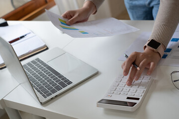 Woman calculate domestic bills at home. Businesswoman using calc