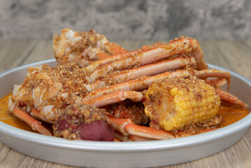 Delicious buttery seasoned snow crab legs with corn on the cob for a great seafood boil