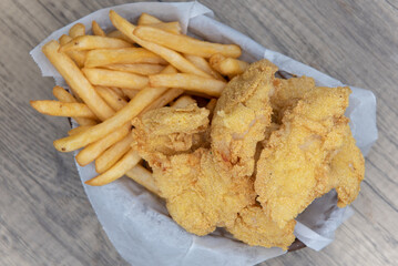 Overhead view of delicious basket of fried fish and chips for a tasty fastfood seafood meal