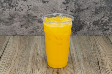 Tasty mango milkshake in a tall cup and ice cold for that thirsty appetite