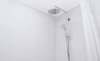 The rain shower head. Modern chrome faucet. Curtain shower enclosures of a wet area in the bathroom.