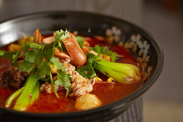 skewered vegetables and meat cooked in a hot and spicy soup