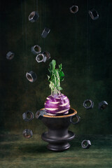 Still life with kohlrabi cabbage and nuts hanging on a string