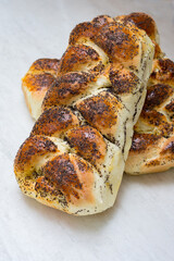 Buns with poppy seeds on a light background of the table, close-up. Baked goods. Cooking concept.