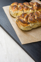 Freshly baked buns sprinkled with poppy seeds on a dark table background. Baking. Cooking concept.