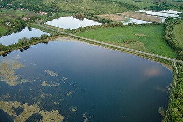 Obraz premium Aerial view of fish hetching pond with blue water in aquacultural area
