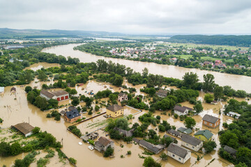 Fototapeta na wymiar Aerial view of flooded houses with dirty water of Dnister river in Halych town, western Ukraine