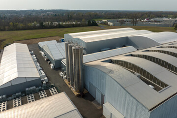 Fototapeta premium Aerial view of modern factory structure for production and distribution of industrial equipment. Concept of global industry
