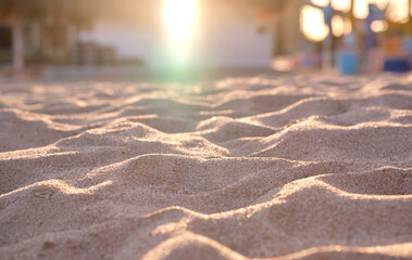 Close up of clean yellow sand surface covering seaside beach illuminated with evening light. Travel...