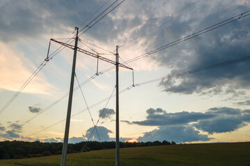 Fototapeta na wymiar High voltage tower with electric power lines at sunset