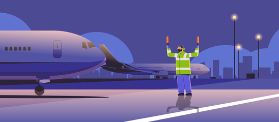 aviation marshaller supervisor near aircraft air traffic controller airline worker in signal vest professional airport staff © mast3r