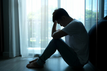 man sitting in the corner of the room have emotional and mental problems He has depression and...
