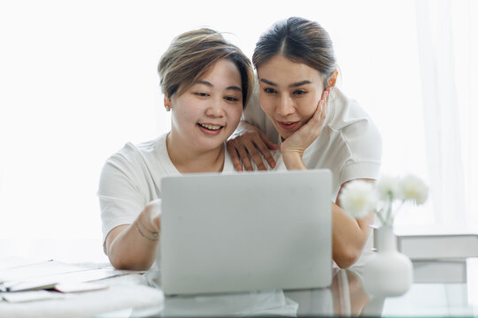 Happy Lgbt Gay Couple Of Asian Women Having Fun Using A Computer Laptop At Home - LGBT Lesbian Relationship, Asian LGBTQ Female Lesbian Concept.