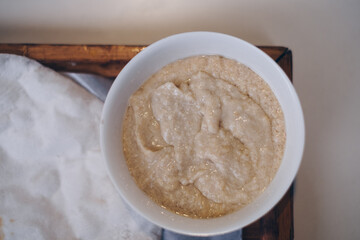 Close up of the popular Pita bread and hummus in white bowl in wooden tray. Flat lay. Selective focus.