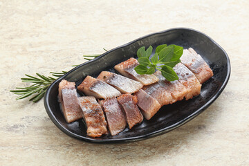 Delicous sliced herring fillet in grape sauce