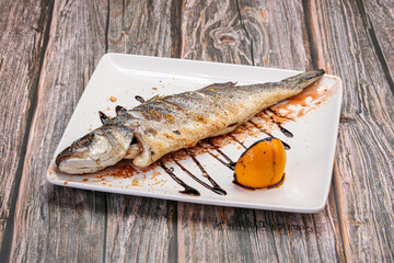 Grilled seabass fish served lemon