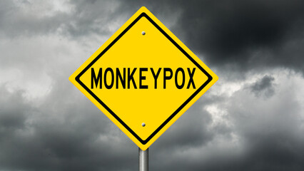 Yellow highway sign warning of monkeypox - obrazy, fototapety, plakaty