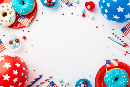 USA Independence Day concept. Top view photo of national flags balloons confetti candles paper baking molds candies straws plates with donuts on isolated white background with copyspace in the middle