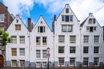Fototapeta na wymiar Amsterdam houses, white color facade and windows, residential neighborhood, Holland Netherlands