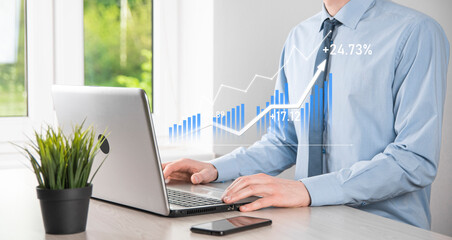 Business man holding tablet and showing holographic graphs and stock market statistics gain profits. Concept of growth planning and business strategy. Display of good economy form digital screen.