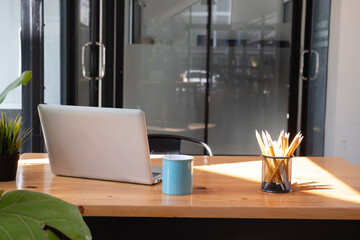 Cropped shot of worktable with mock up two laptop, stationery and supplies in co working space.