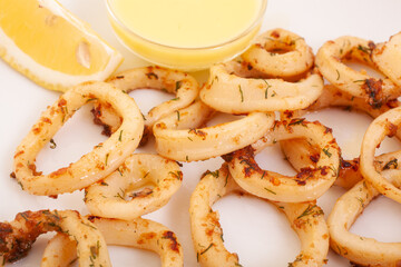 Calamari rings, squid rings, with sauce and lemon