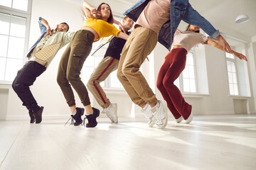 Group of young hip hop dancers rehearse together and learn new choreography in dance studio....