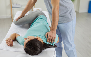 Close up of therapist do exercises with female patient in wellness clinic. Physiotherapist work...