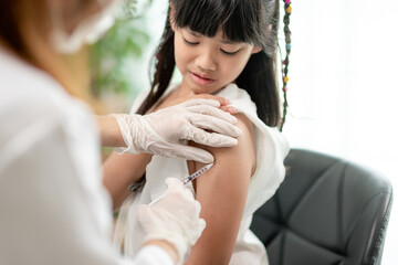Obraz na płótnie Canvas Successful covid-19 vaccination. cute little girl while being immunized against coronavirus