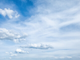 Fototapeta premium Stratified clouds with occasional small cumulus clouds.