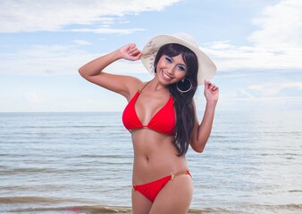 Sexy asian red bikini female lady model having a great holiday by a beach and posing  happily with different enjoy look and moment, suitable for glamour travel summer ads 