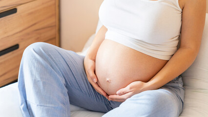 Pregnancy yoga meditation. Health yoga home sport. Beautiful pregnant woman meditating while sitting in lotus position. Concept maternity, pregnancy, childbirth.