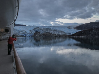 Breathtaking landscape and scenery with mountains, glaciers and fjords on misty day during cruising...