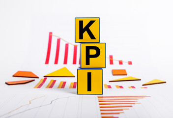 Key performance indicators. Failure in objectives achievement. Cubes with KPI text and graphs showing business decline. Strategic planning. High quality photo