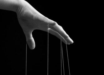 Woman hand with strings on fingers. Violence, harassment, bullying concept. Female suffering from...