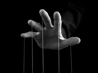 Man hand with strings on fingers. Manipulation, power concept. Male making person feel fear,...