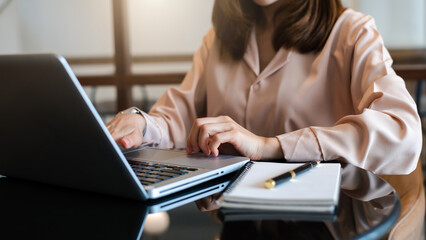 Working Process in Modern Office. Young Woman Account Manager Working at Table with New Business Project. Typing keyboard,Using Contemporary Laptop.