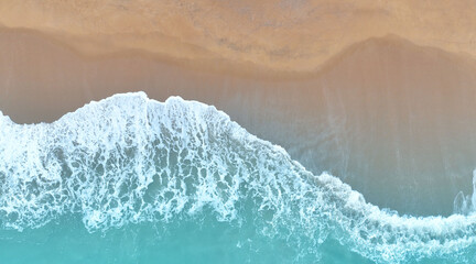 Fototapeta na wymiar Aerial view Top view of Beach sand copy space Beautiful sea waves in Summer tropical background